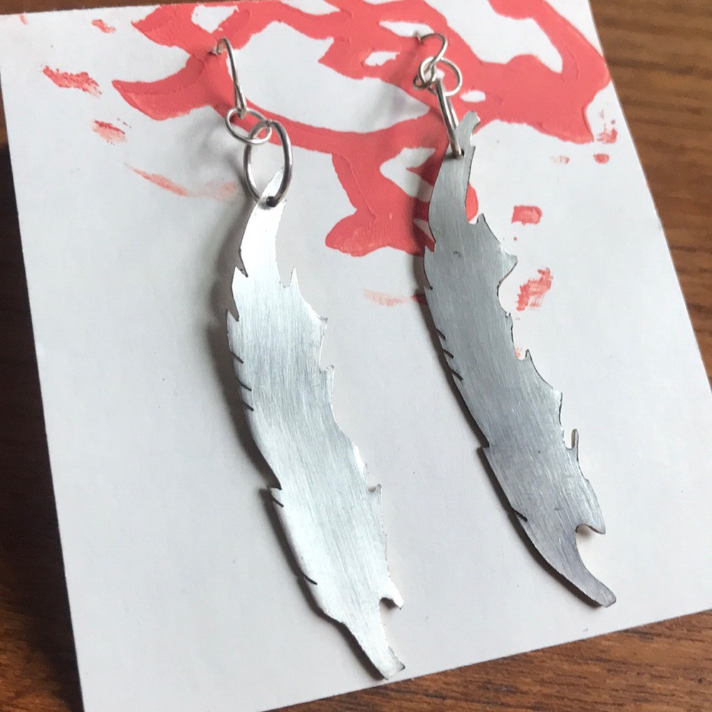 Silverplated brass-edged feather dangle earrings
